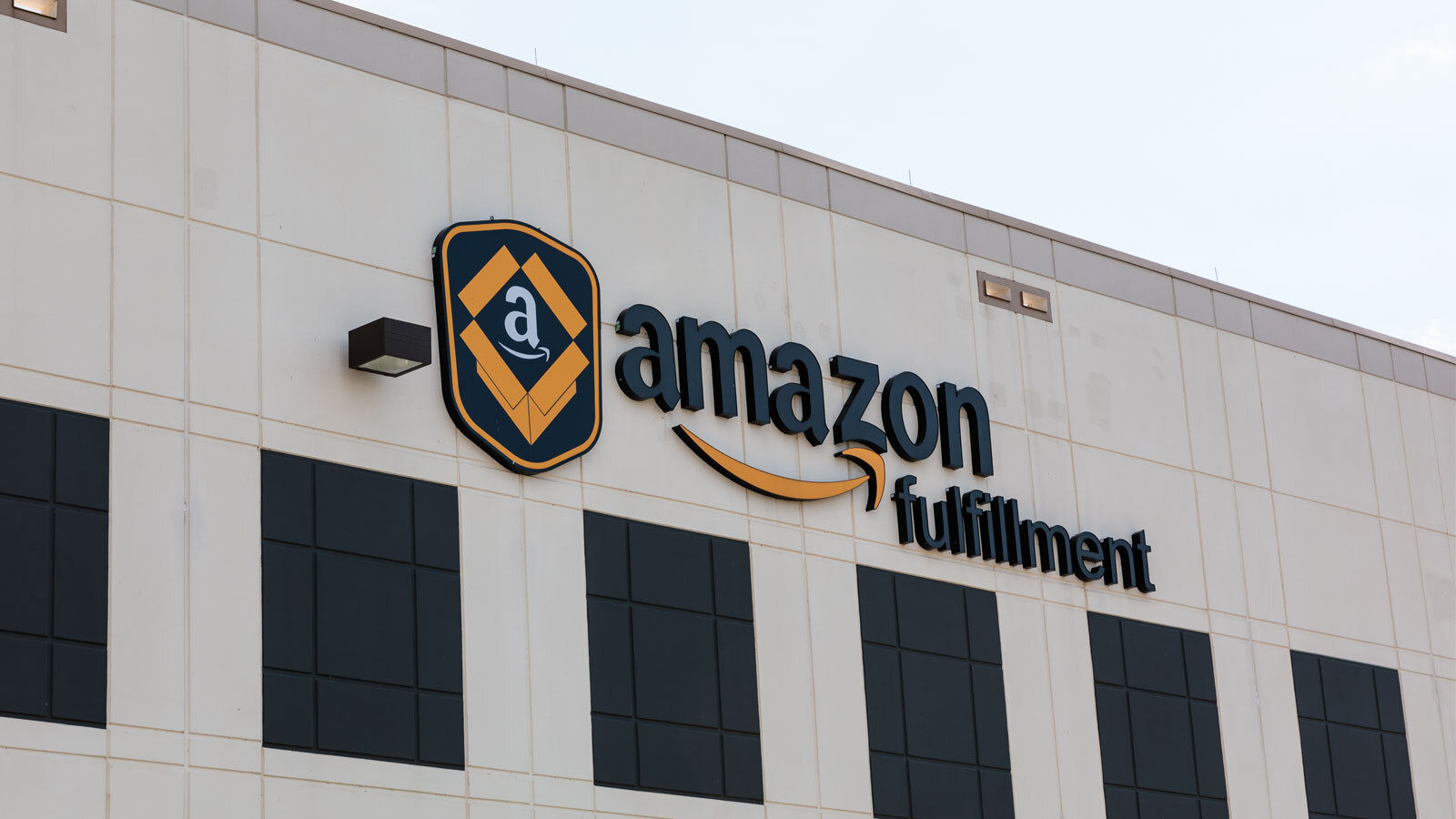 An image of the outside of a large building with a sign that says "Amazon Fulfillment"