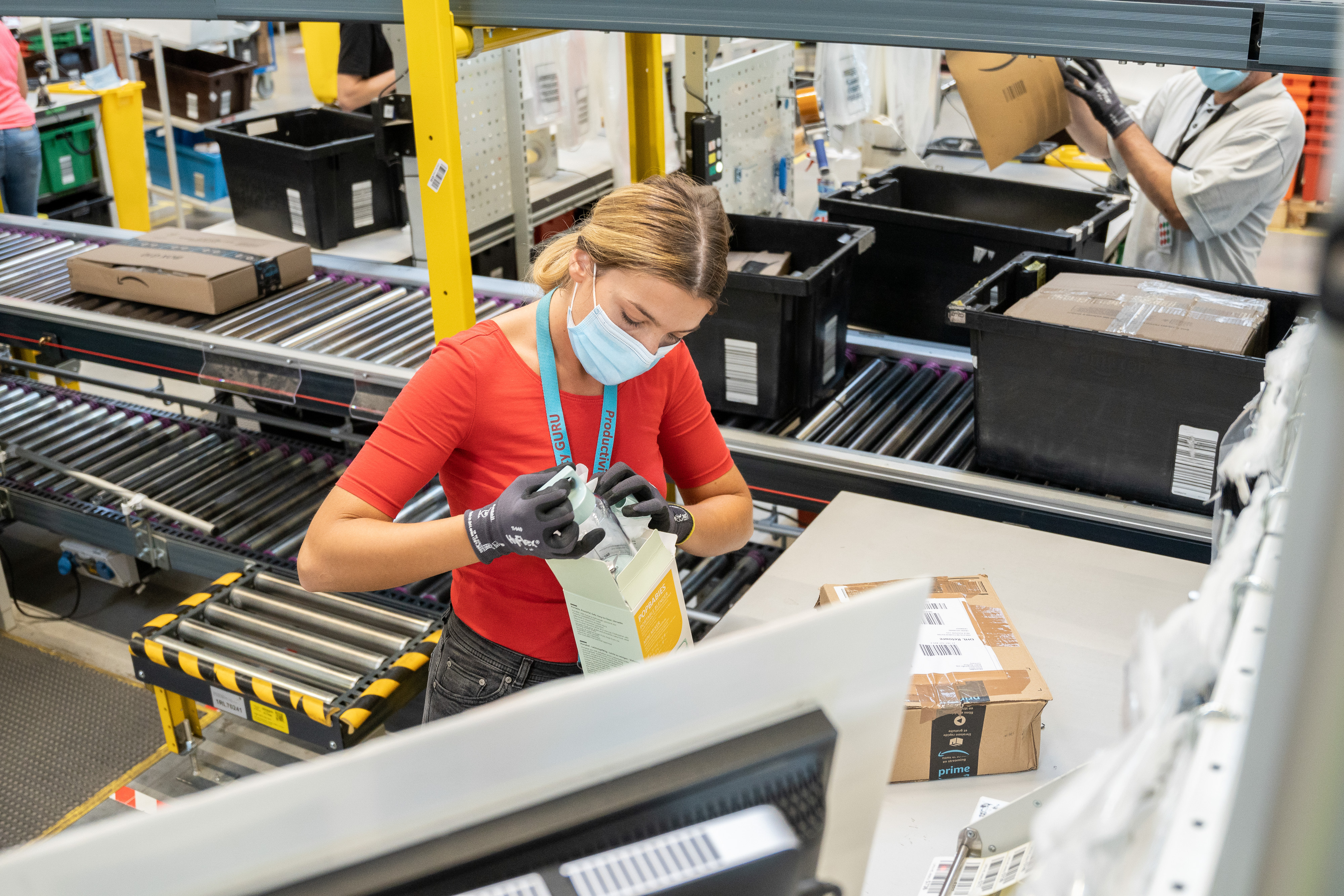 amazon employee inspects returned products at fulfilment centre