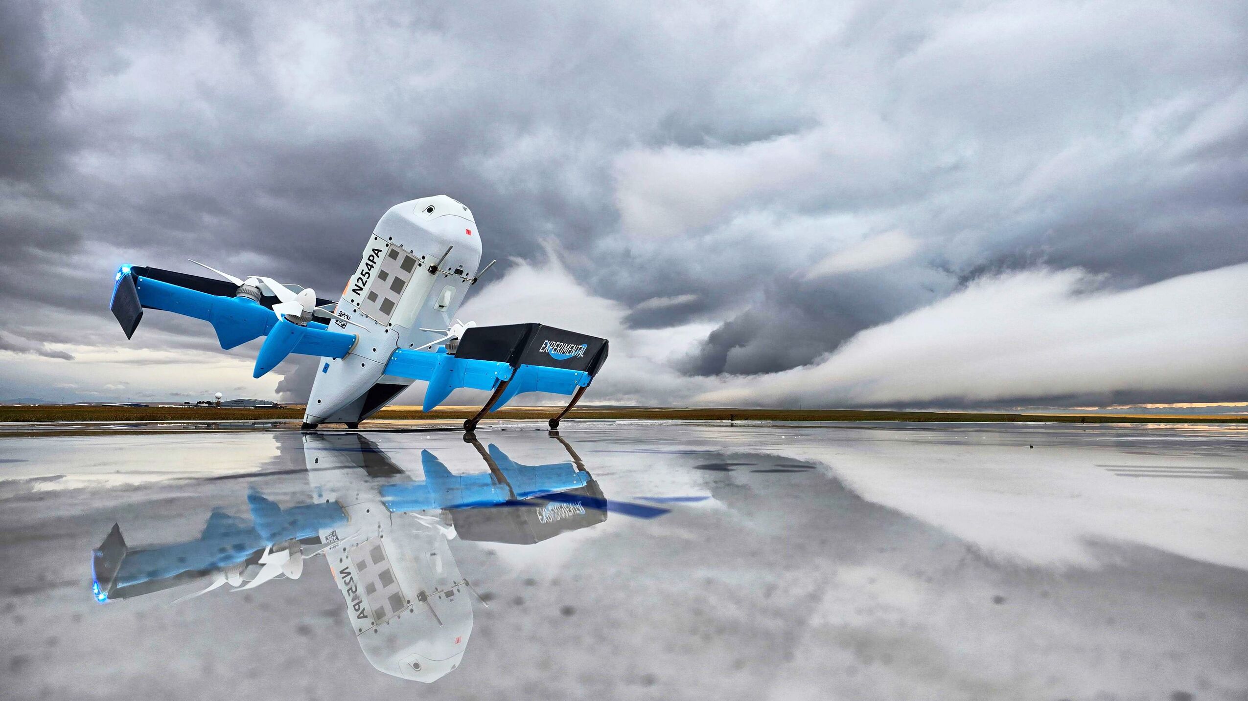 Drone on reflective wet runway under stormy sky