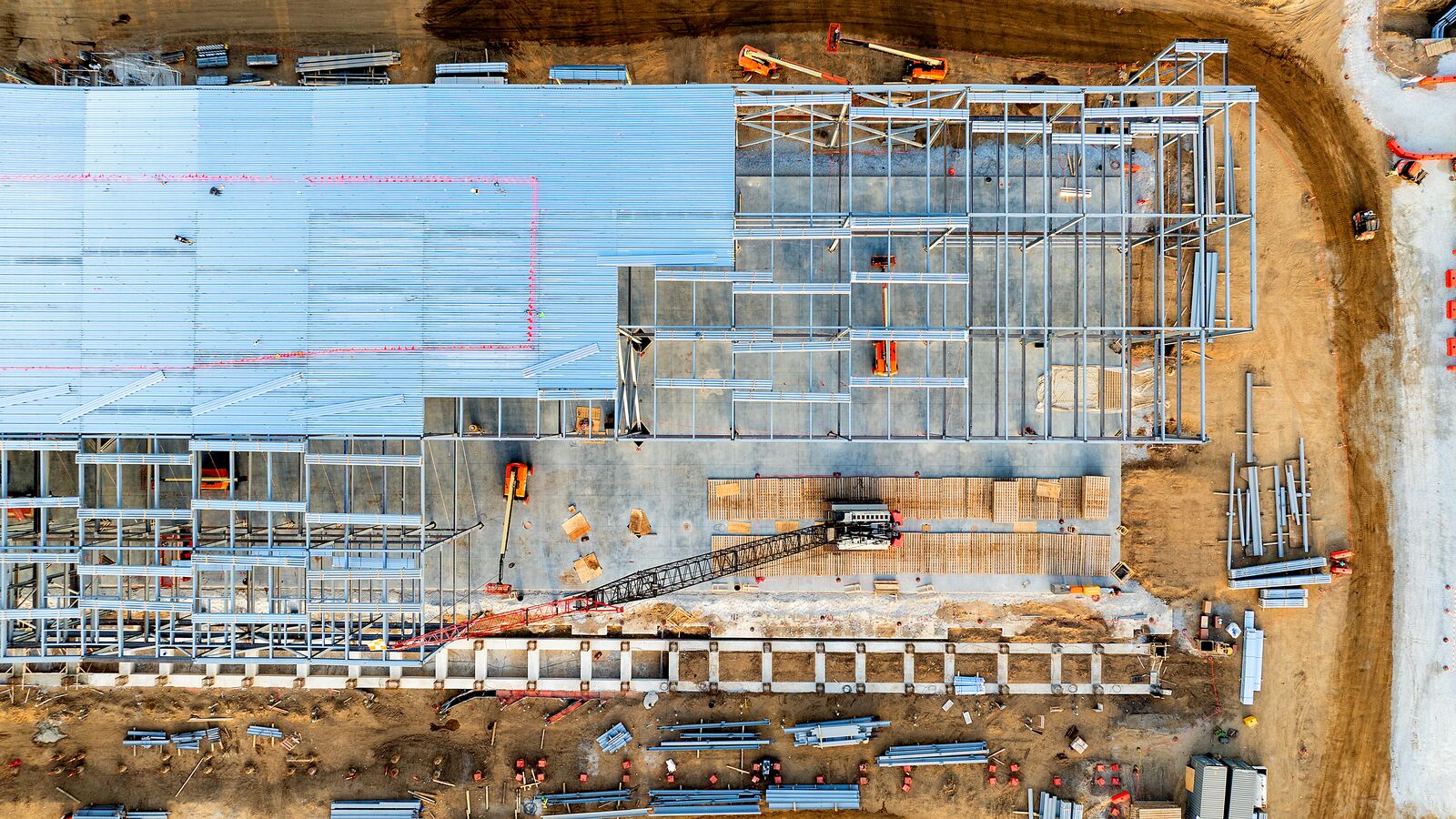 Aerial view of large-scale construction site for data center with steel framework
