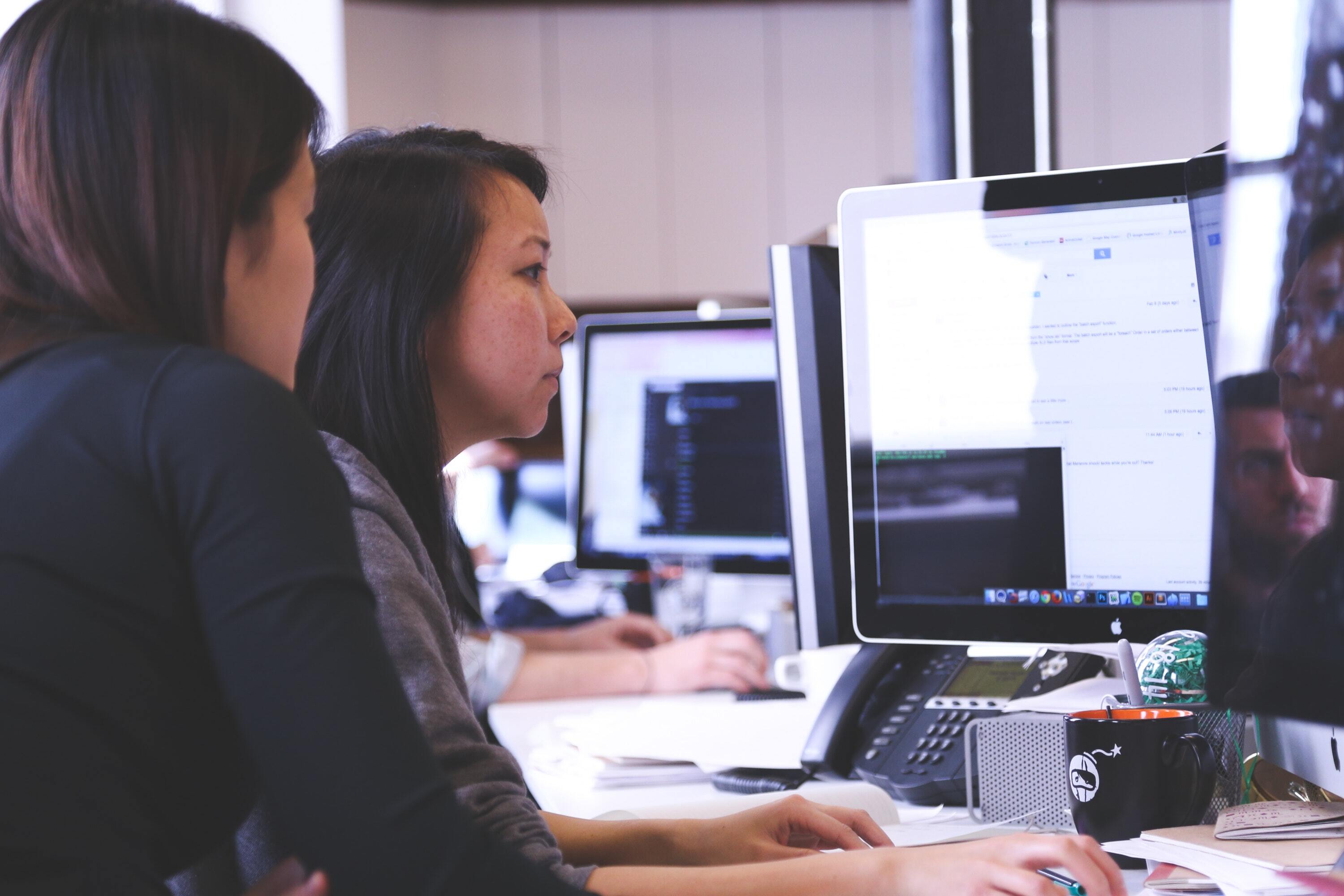 Women working on computer, coding 