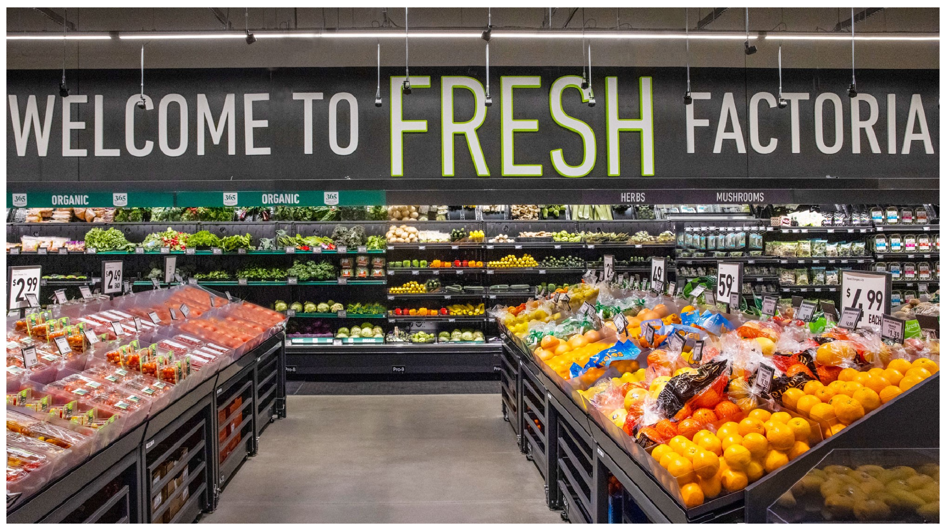 The fully stocked produce section of the new Factoria Amazon Fresh store. A sign above the produce reads, welcome to fresh Factoria.