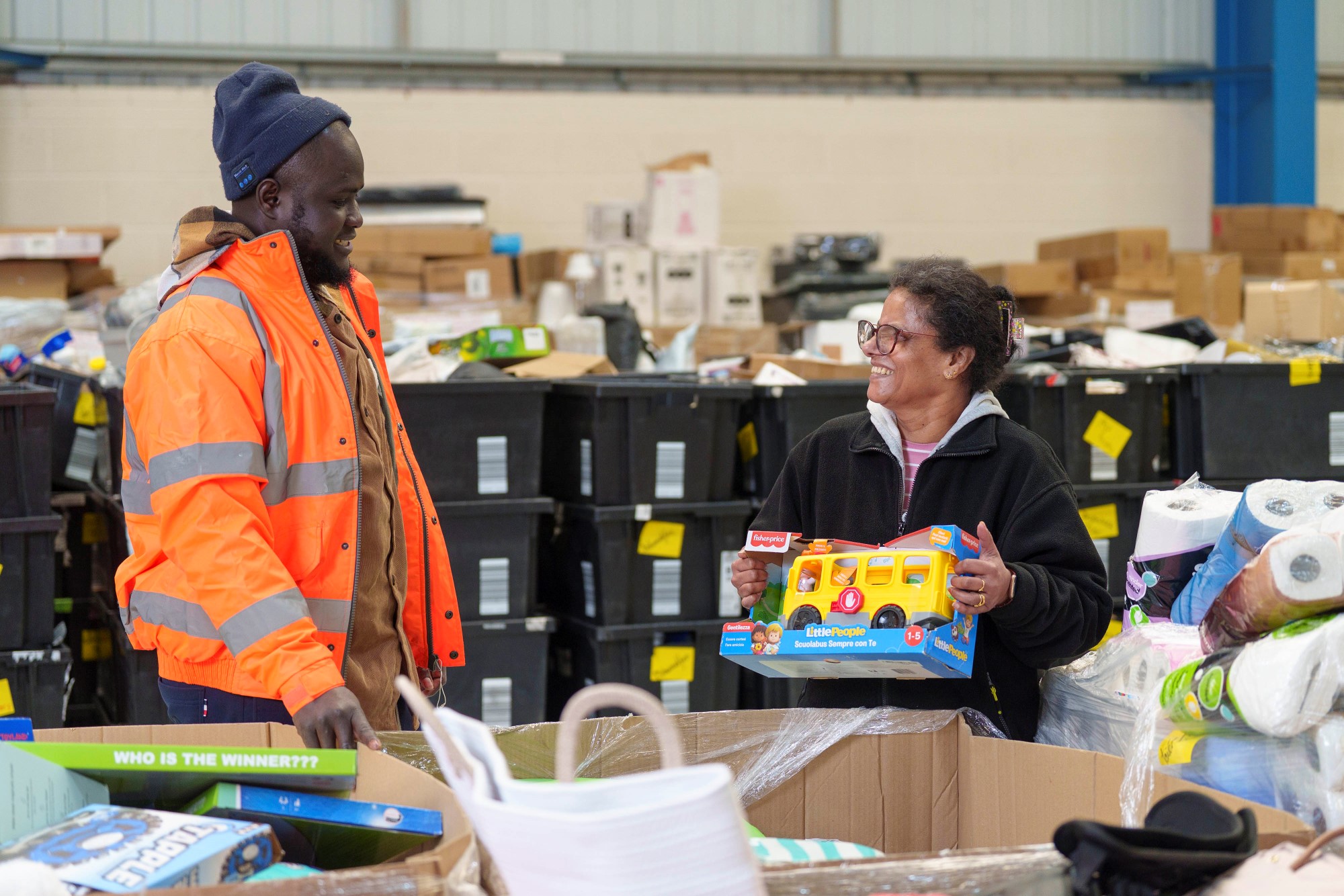 Two people prepare goods at the West Midlands Multibank ahead of its opening