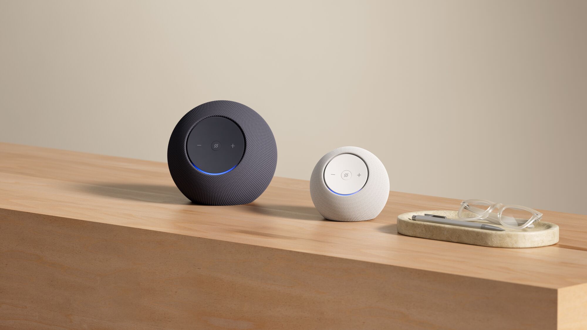 Smart speakers in black and white on wooden surface with glasses