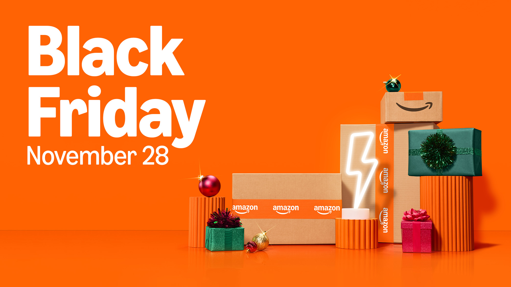 Amazon Black Friday November 28 sale advertisement with stacked packages and holiday decorations