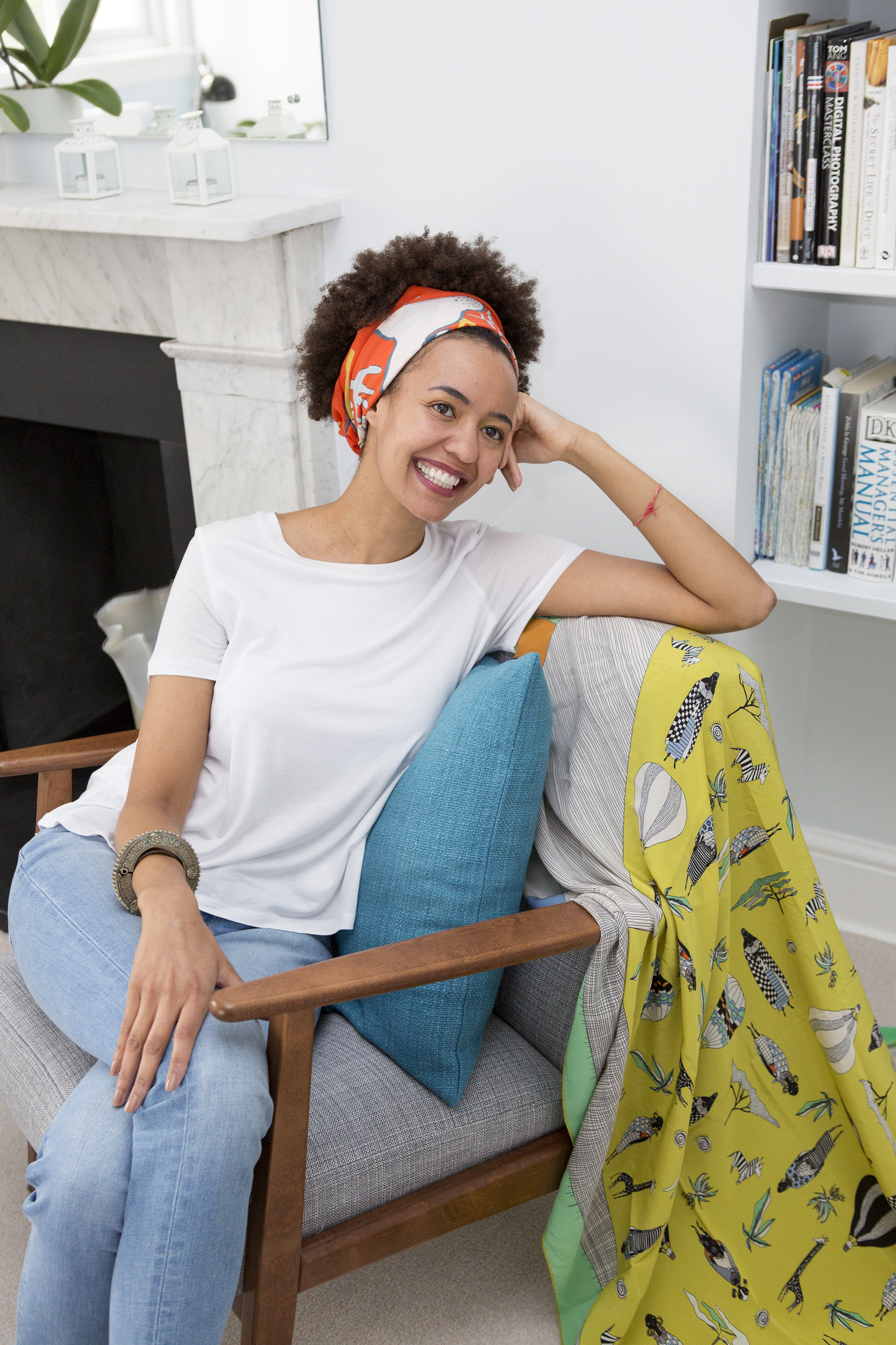 Katie George sat on a wooden chair smiling at the camera