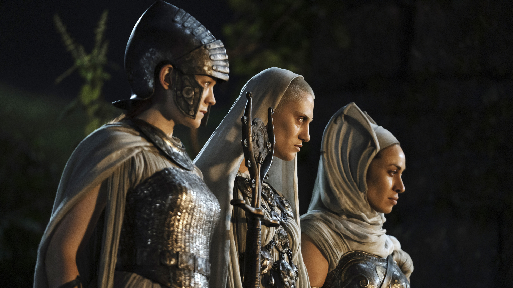 Three characters in silver armor stare menacingly into the distance.