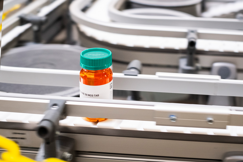 An Amazon Pharmacy prescription bottle in a fulfillment center.