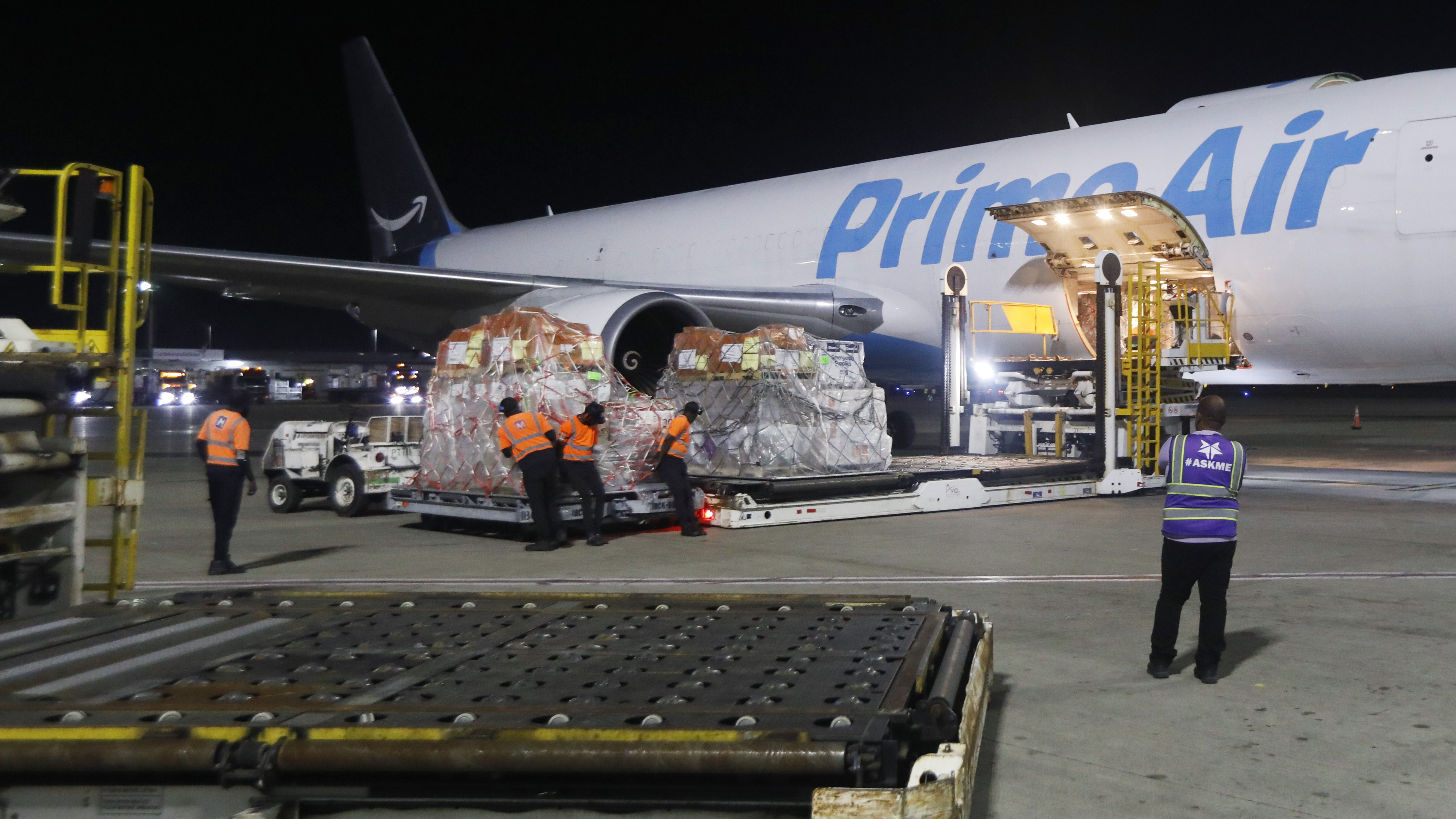 Cargo being loaded onto Prime Air plane at night