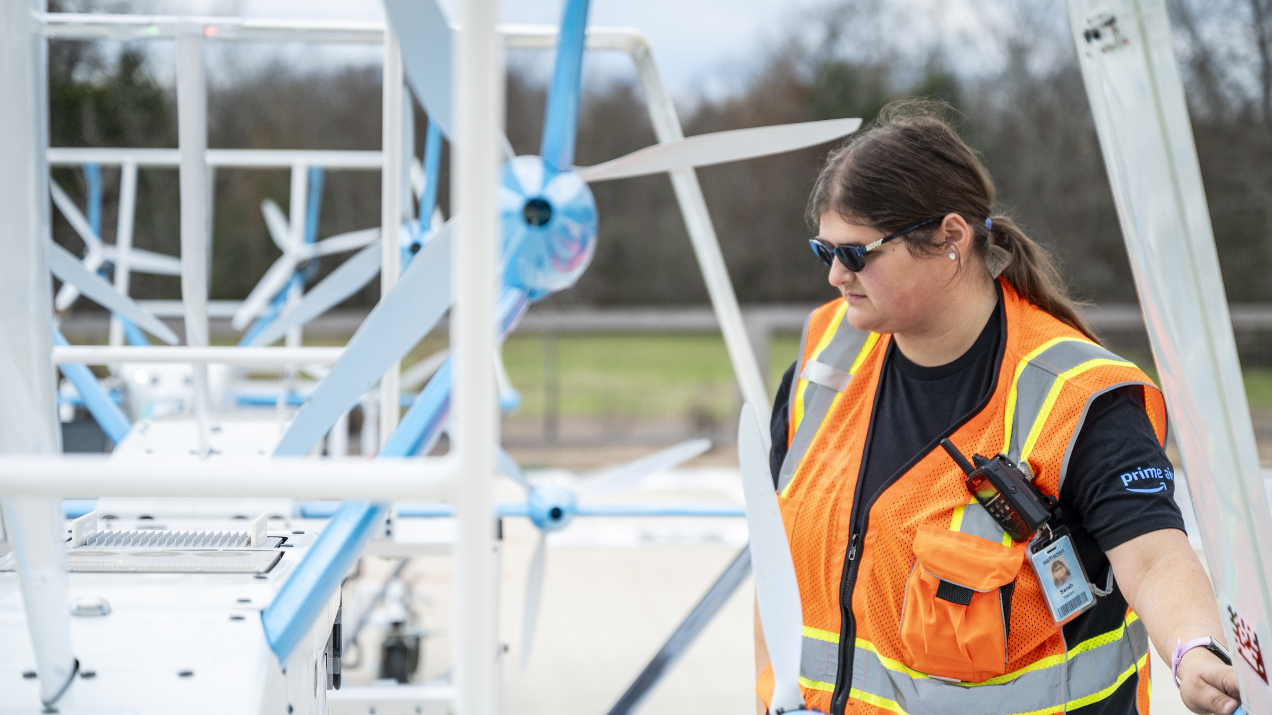 An Amazon employee inspects a drone after its flight