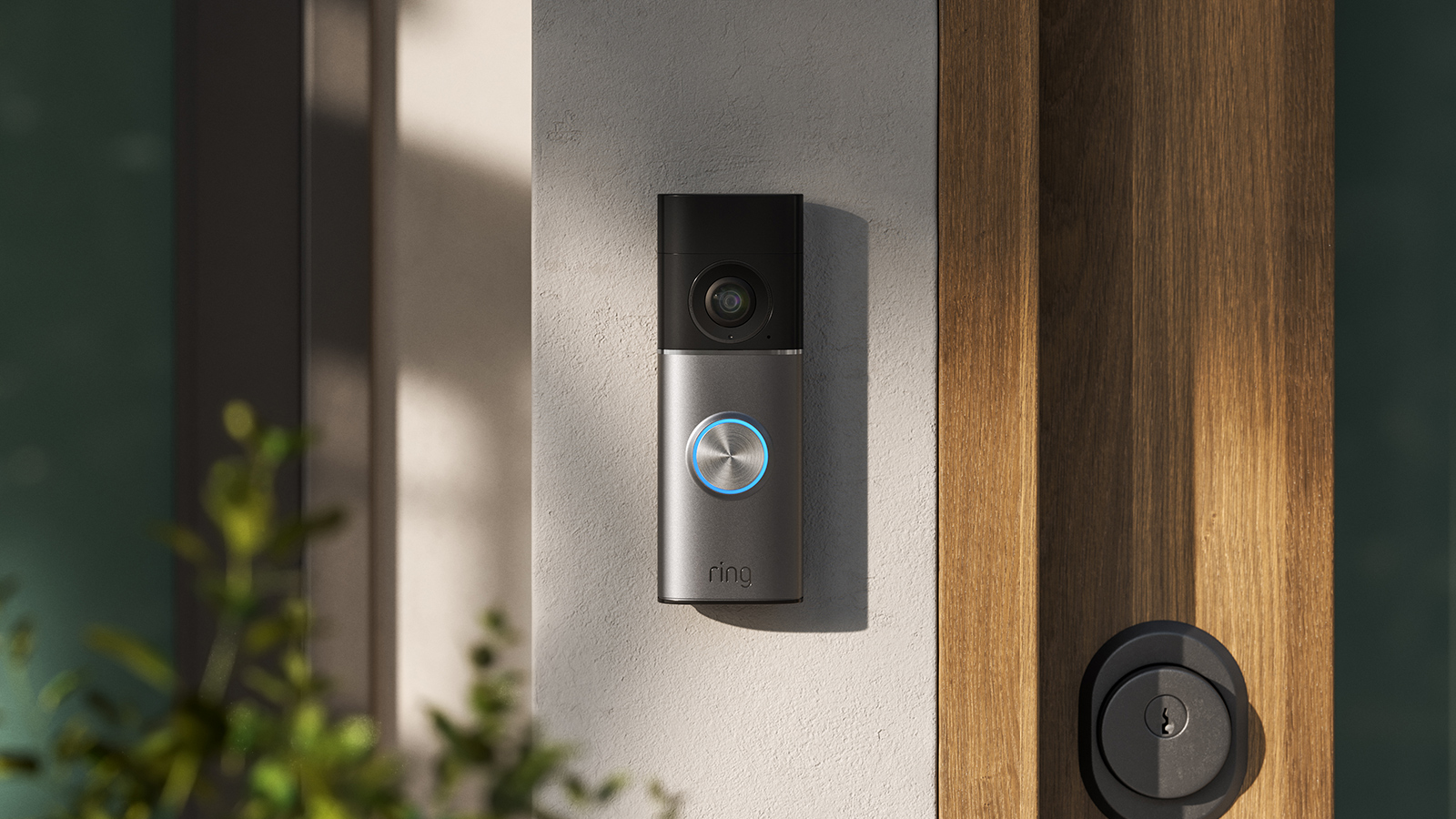 Ring video doorbell mounted next to wooden door frame
