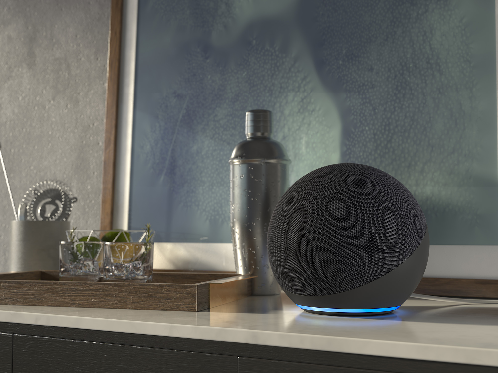 An image of an Echo device sitting on a side table next to a framed artwork and other home decor.