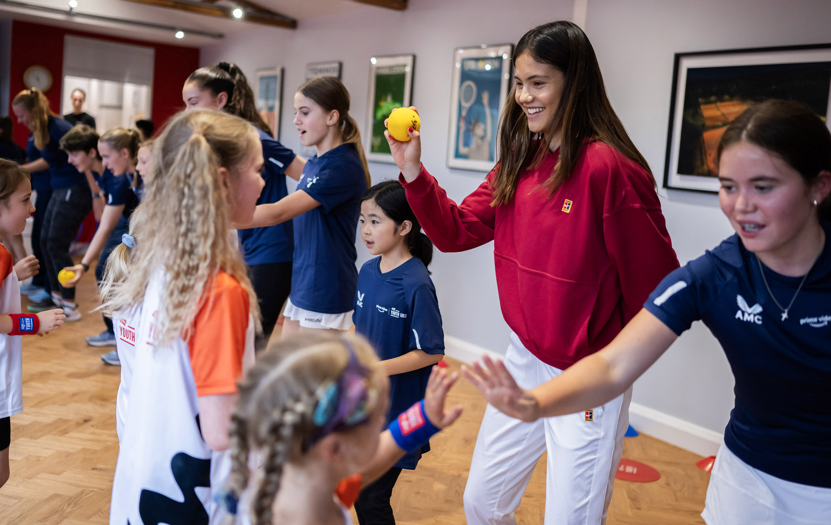 Tennis star Emma Raducanu teaches young girls how to play tennis 