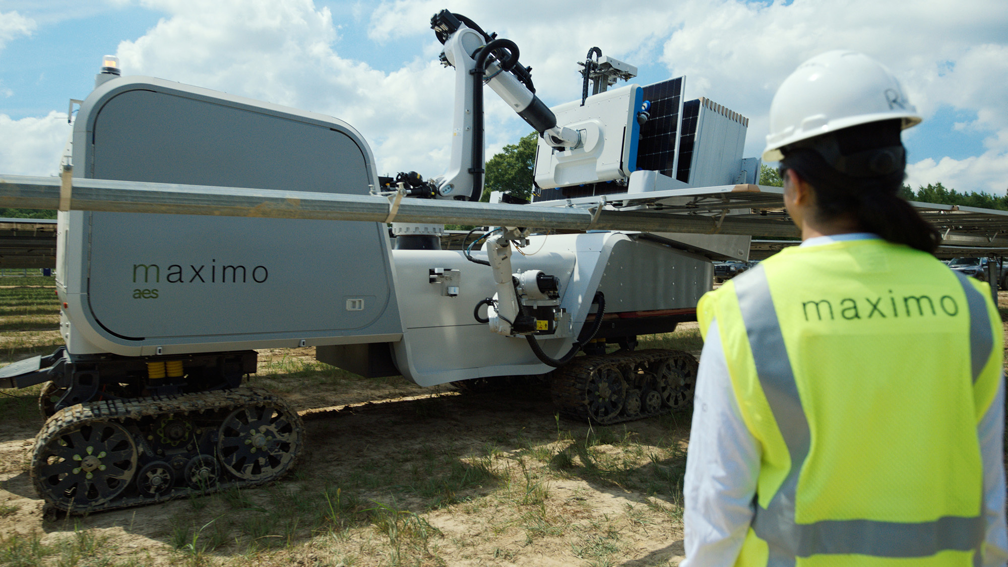 Autonomous sustainability robot on tracks with robotic arm, operator watching