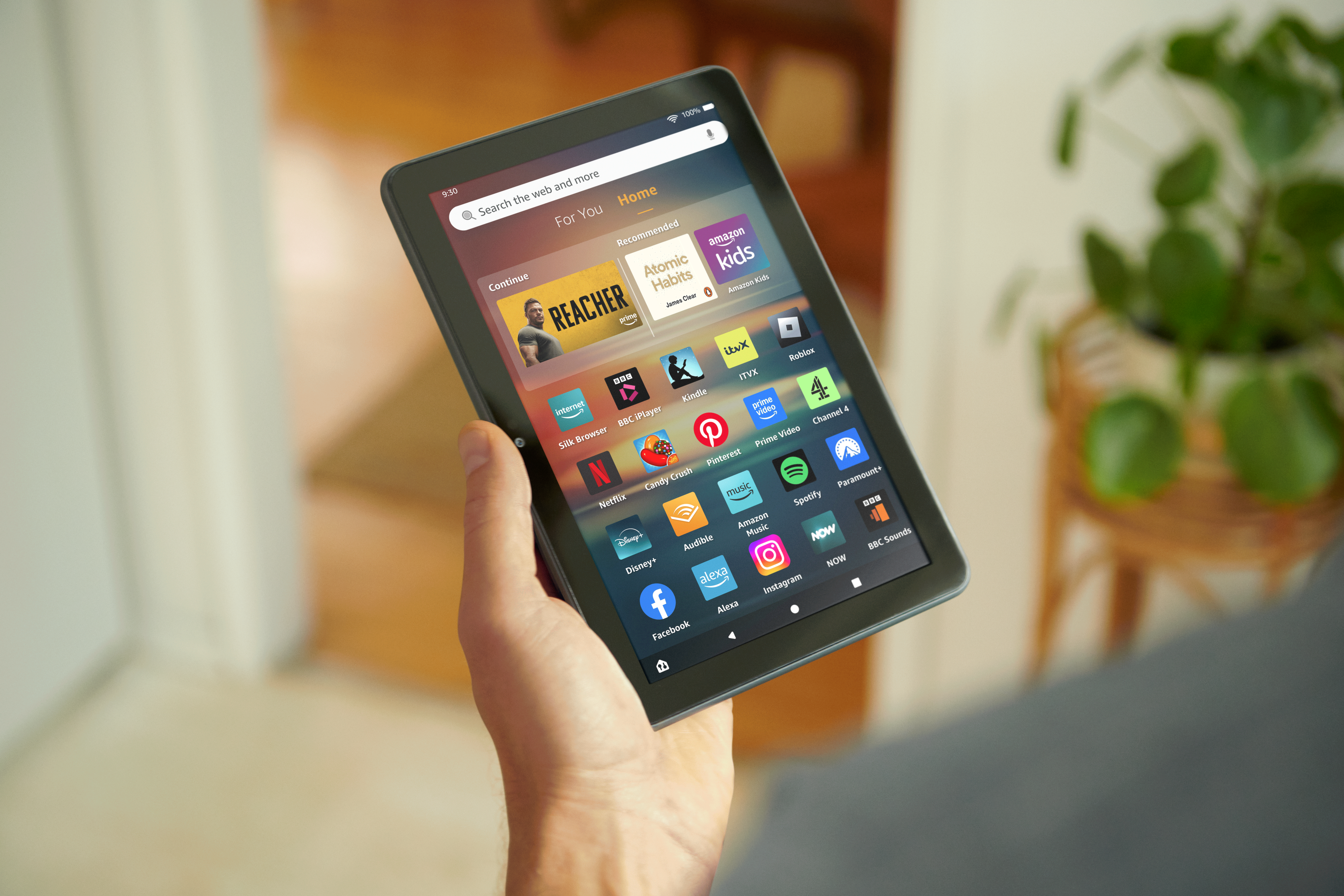 A hand holding the new Fire HD 8 Tablet