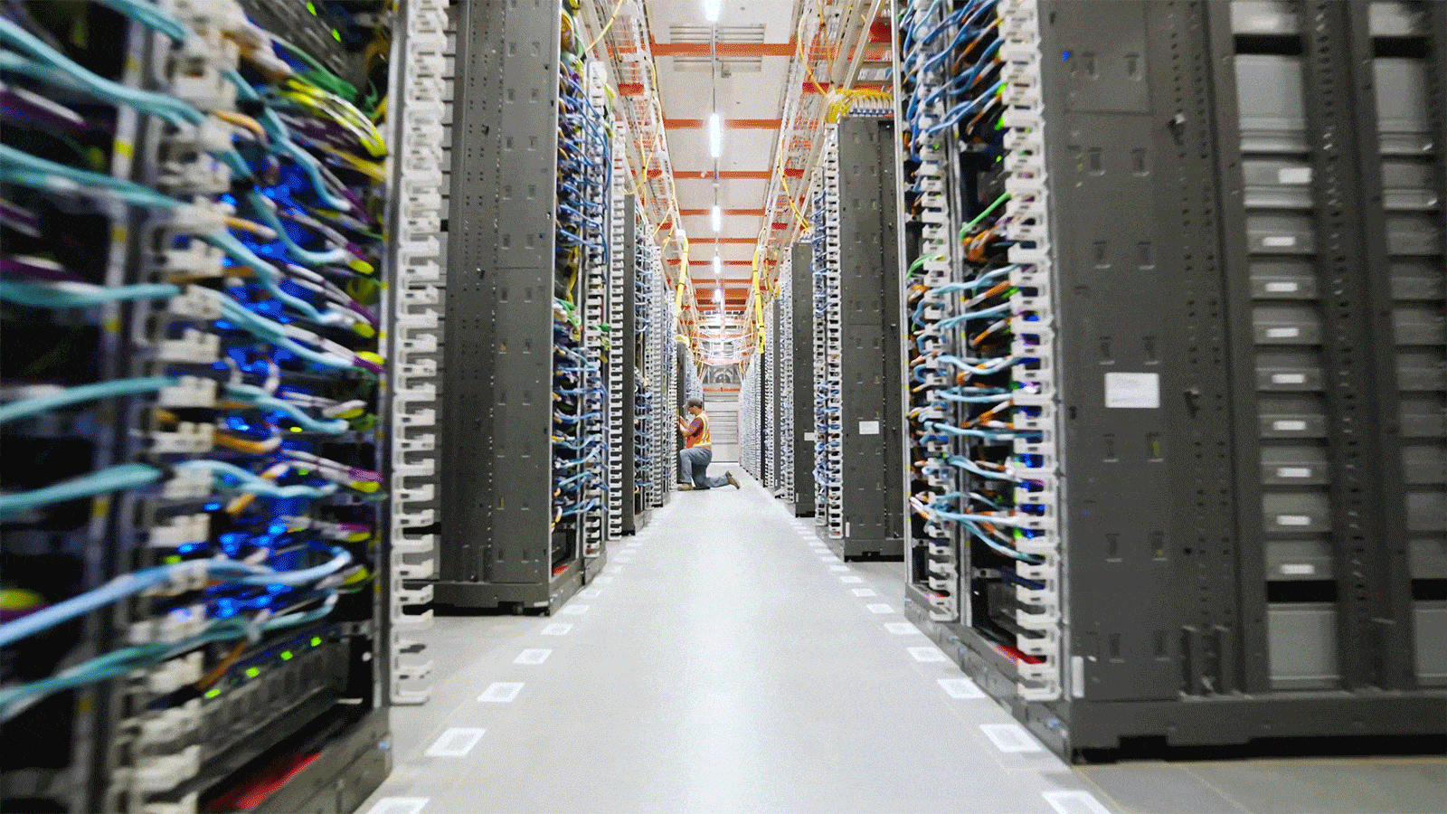 A motion view within a hallway of UltraServers within a data center.