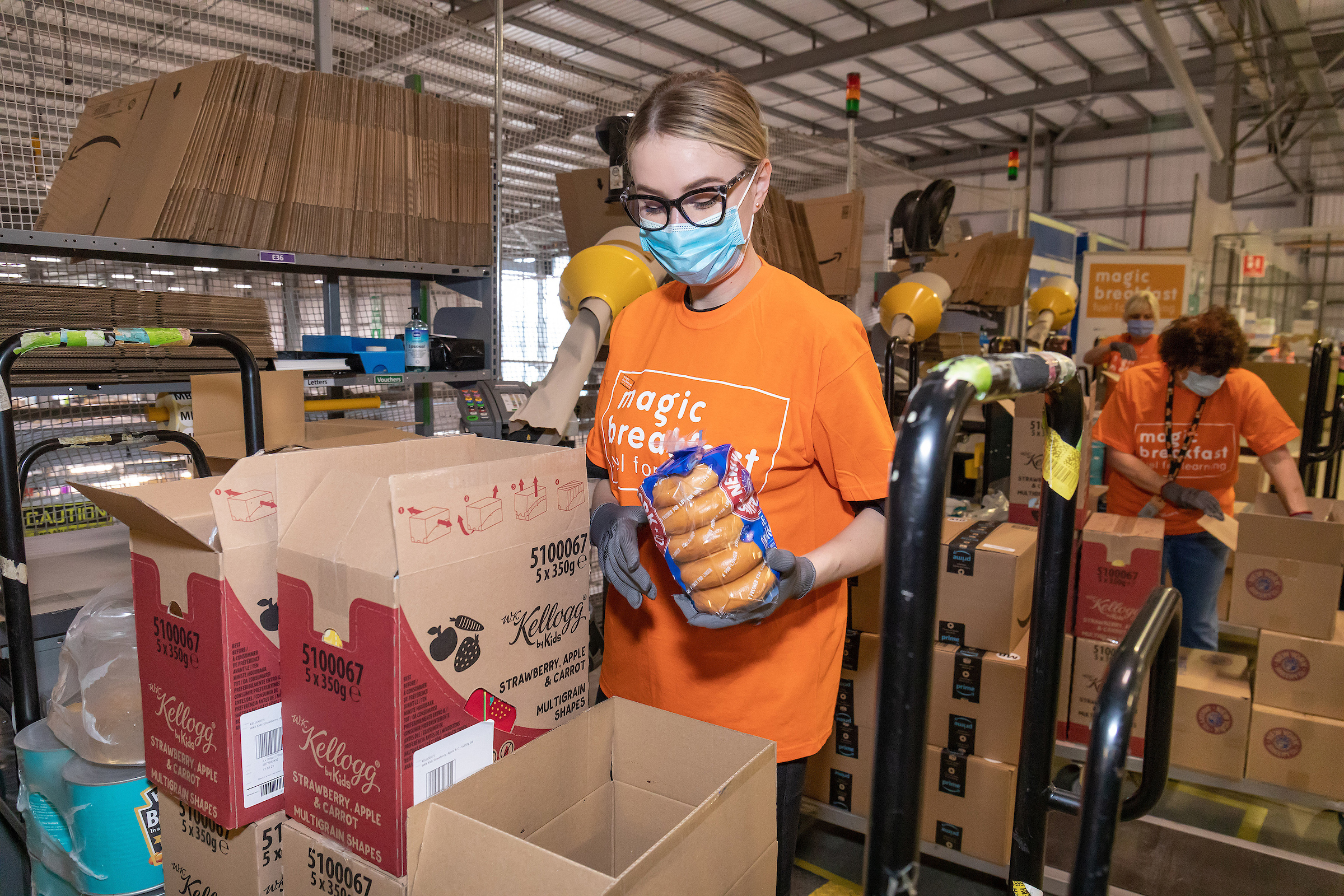 Female team member packing boxes for Magic Breakfast 