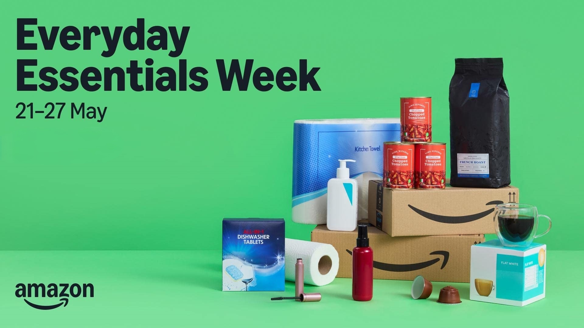 Amazon boxes surrounded by various household products on a green background
