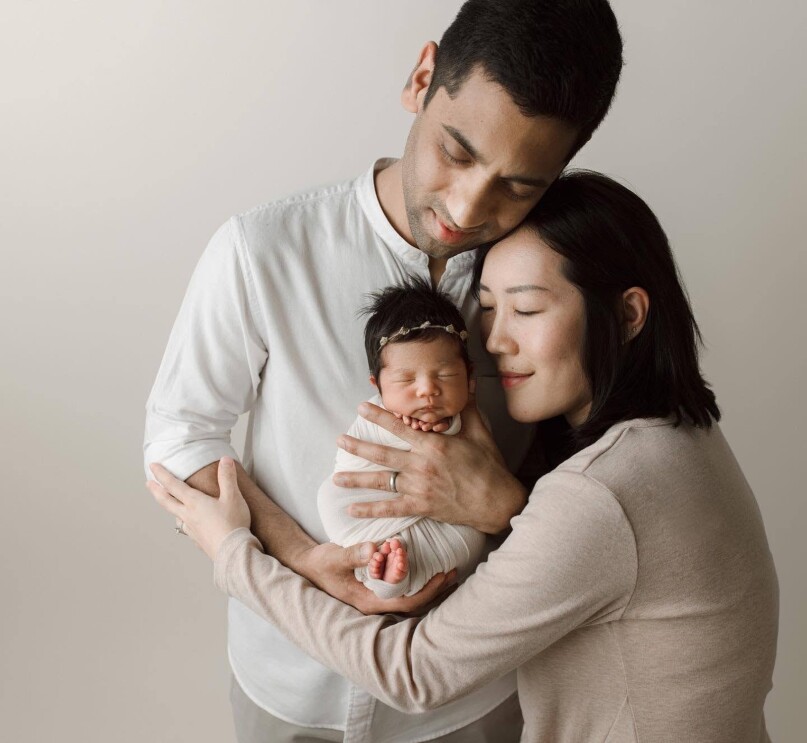 Lyanna and her husband cradling her newborn daughter