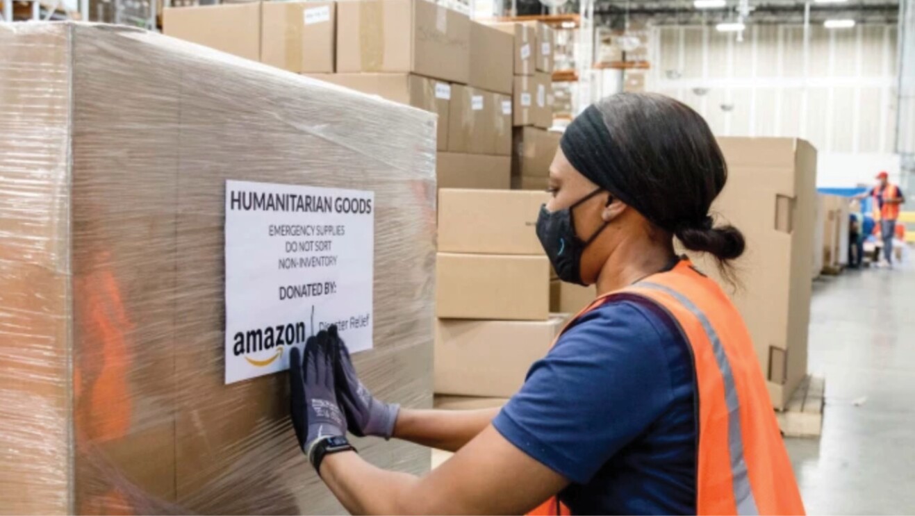 An amazon employee packs boxes of relief items to ship to Florida