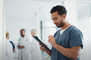 A photo of a healthcare employee working on a laptop. 