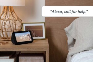 An image of a black Echo Show sitting on a nightstand and a text box at the top that reads "Alexa, call for help."