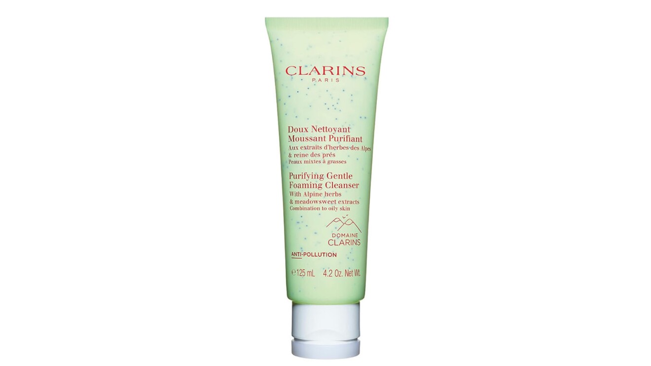 An image of a bottle of cleanser from Clarins. It comes in a tall, light green tube with red lettering and a white lid.