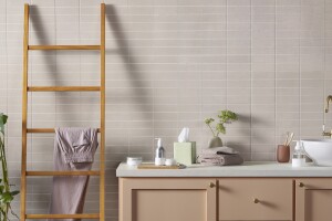 A picture of several new Amazon Aware products on a bathroom counter and leaning towel rack. 