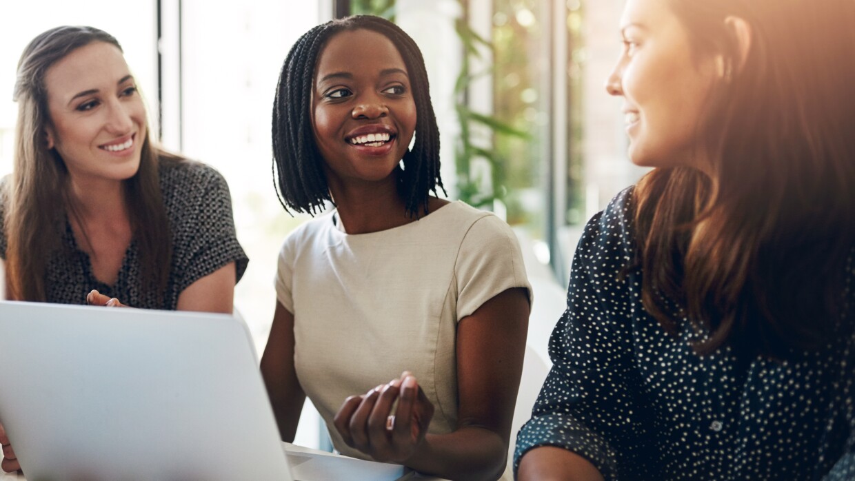 Business women, conversation and laptop data with planning and strategy in office. Training, communication and online chart with corporate tech and working on a teamwork project with diversity image