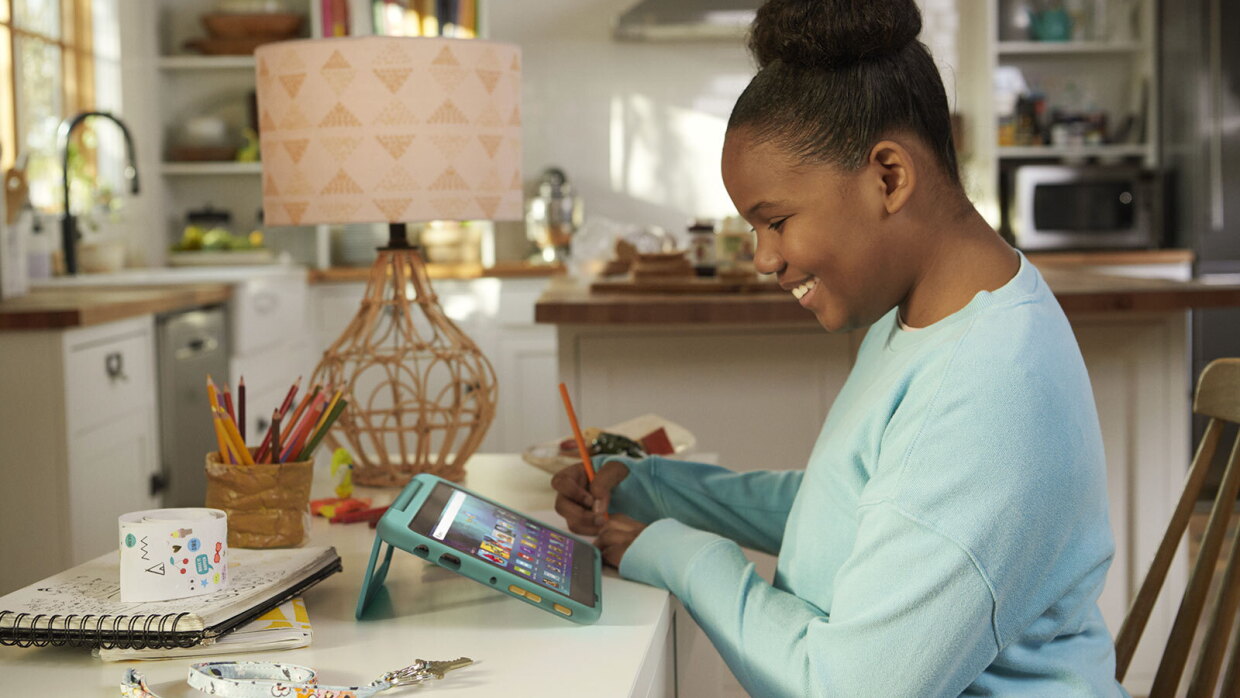 An image of a child using Amazon's Kids Fire Tablet in their home.