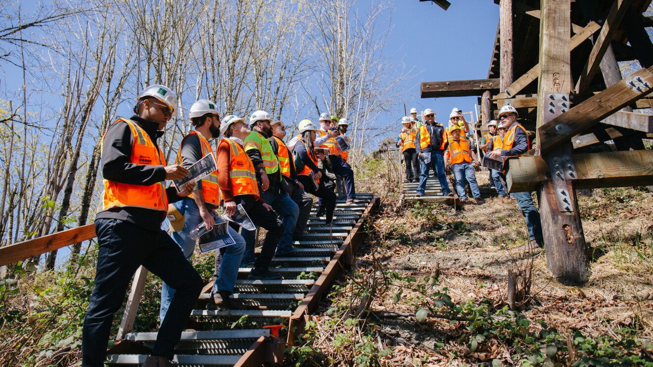 Constructions workers discussing the Wilburton Trestle