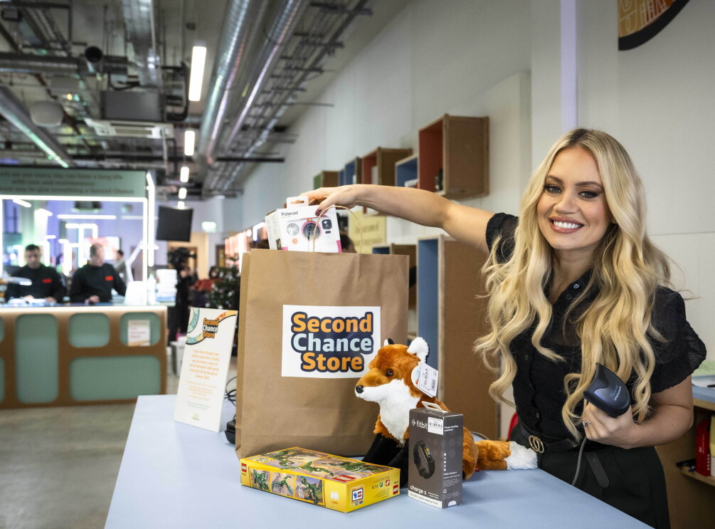 Kimberly Wyatt packs a paper bag at the Second Chance Store. 