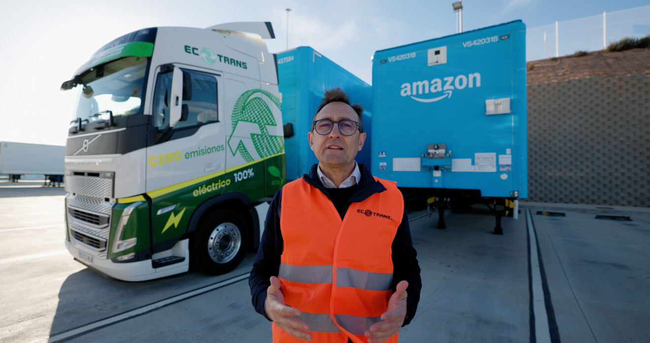 Ecotrans representative stands in front of Amazon electric truck