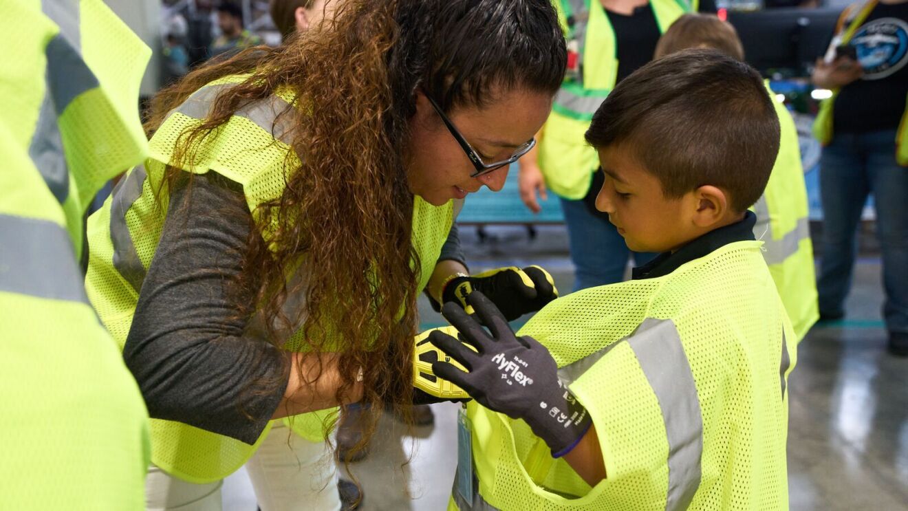 Kids join their parents at work at an Amazon Fulfillment Center.