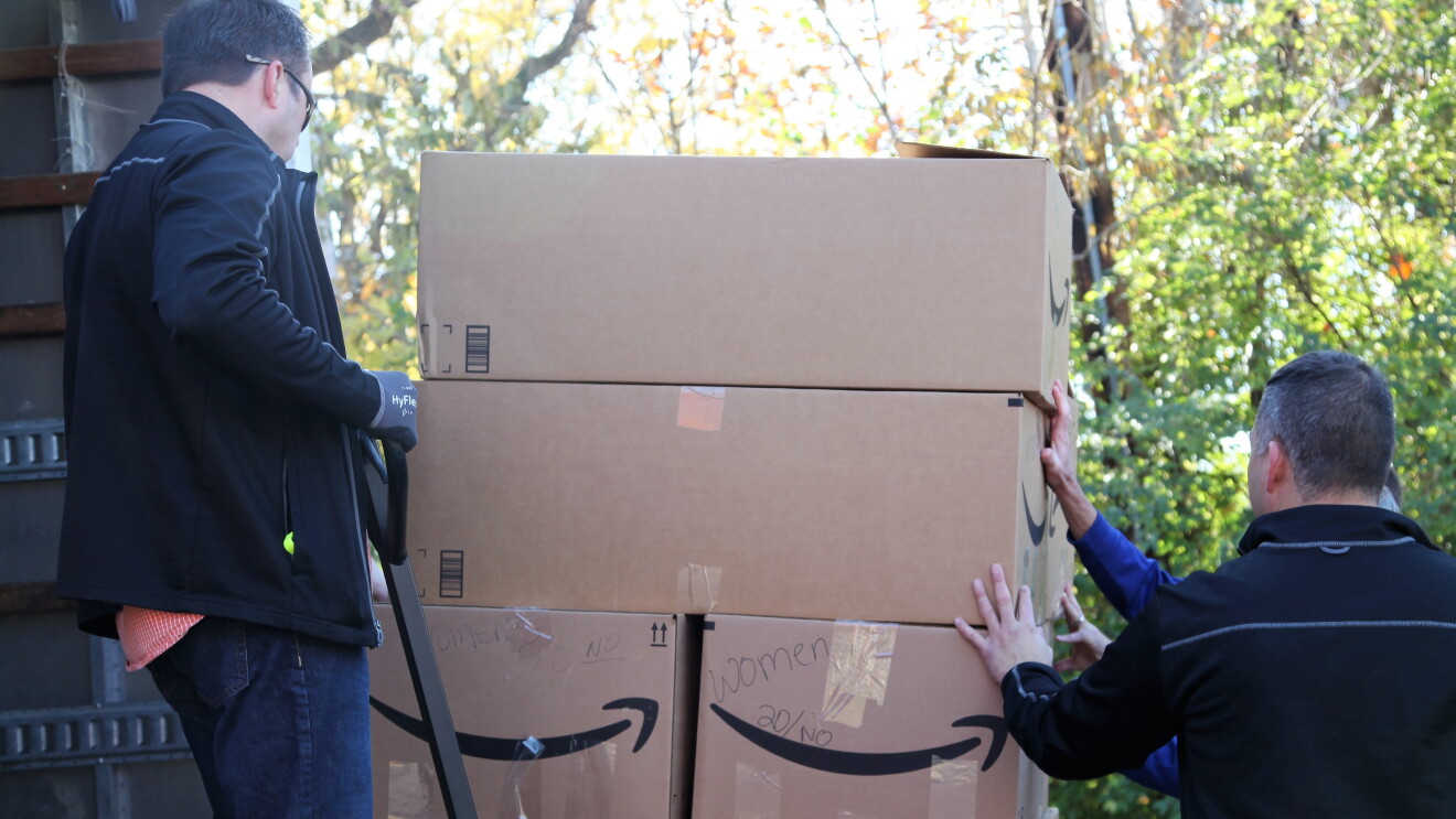 Amazon associates unload supplies for backpacks
