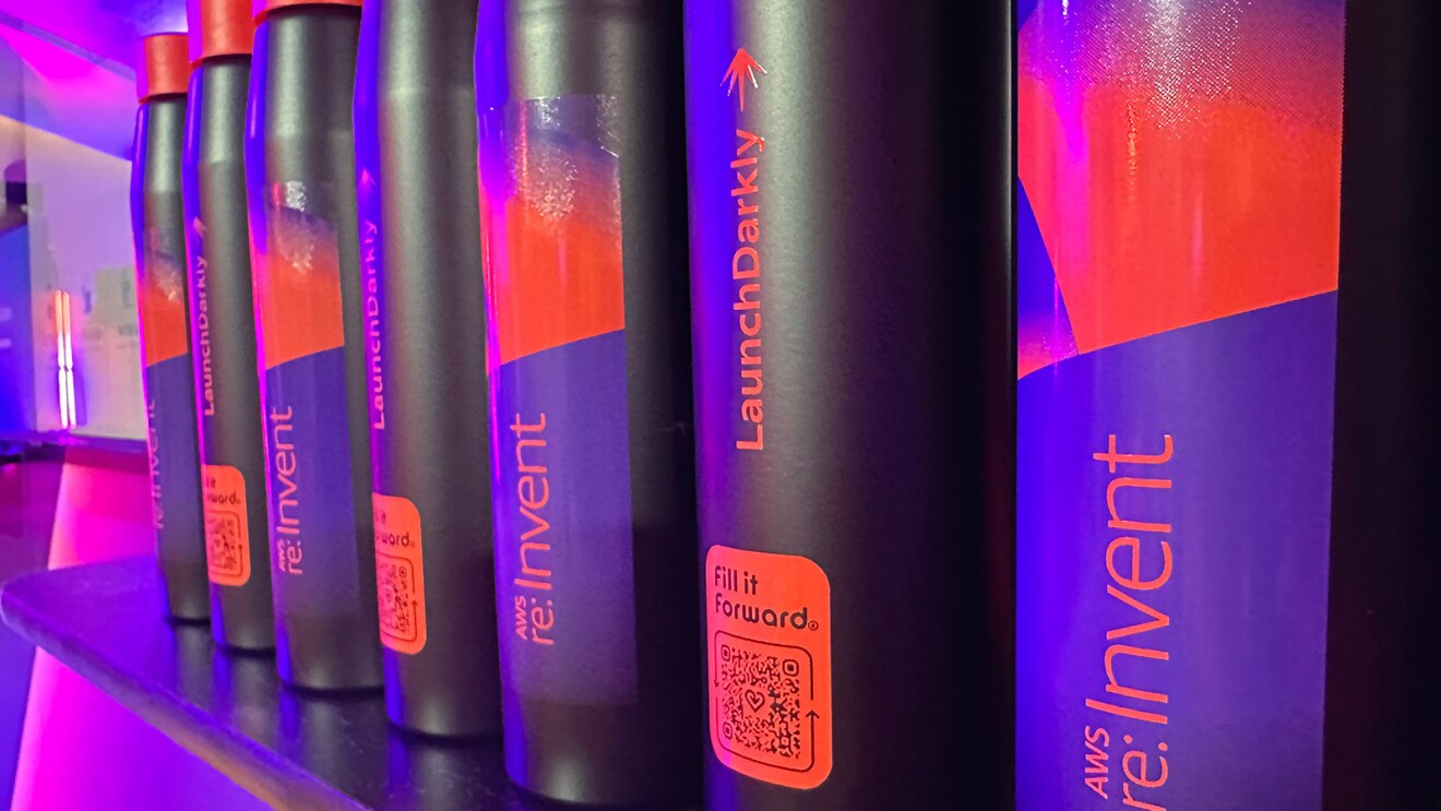 A photo of 'Fill it forward' water bottles on a shelf at AWS re:Invent.