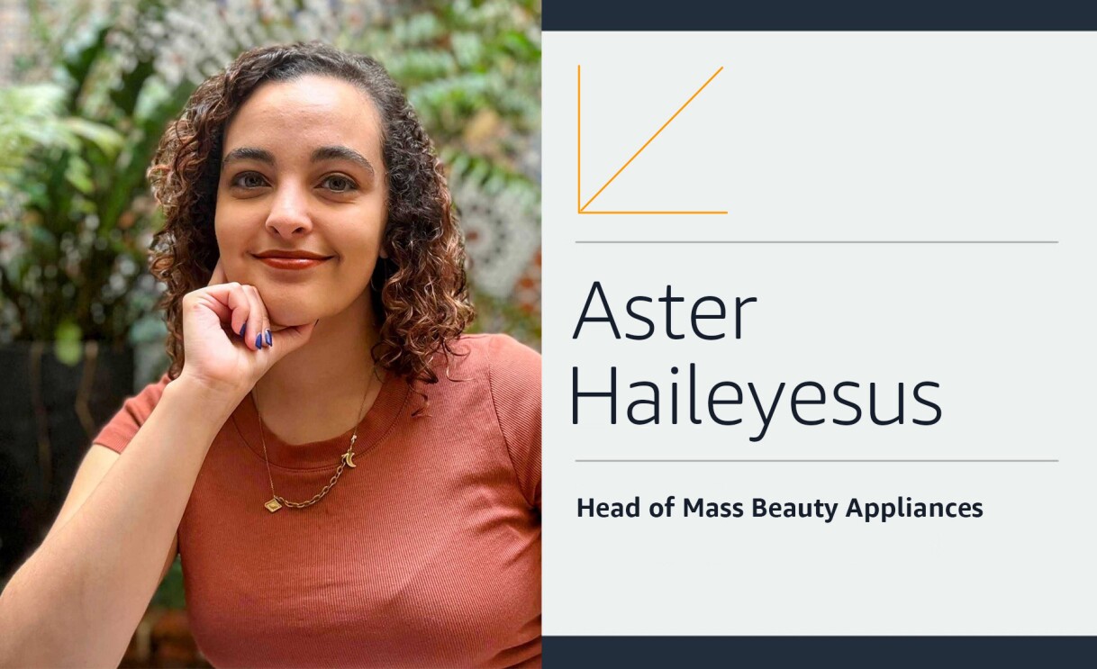 Aster Haileyesus has her hand on her chin and is smiling.