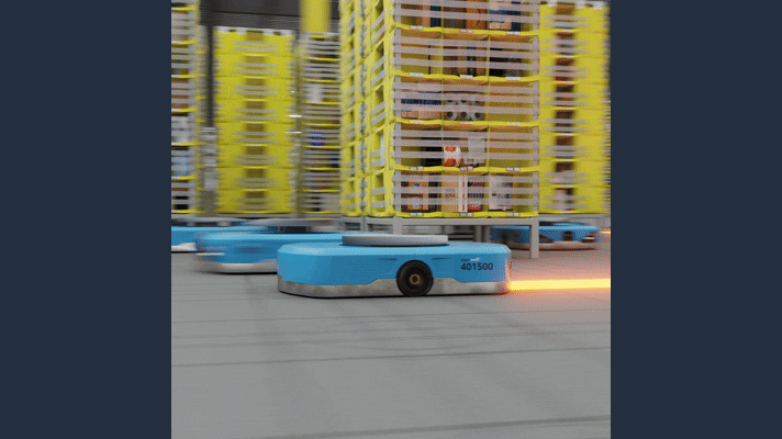 Automated guided robot navigating Amazon warehouse shelves using DeepFleet, a new AI technology