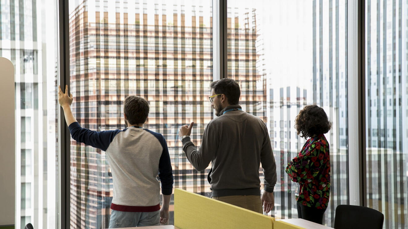 Amazon employees looking out from the window at the Seller Support office in Barcelona 
