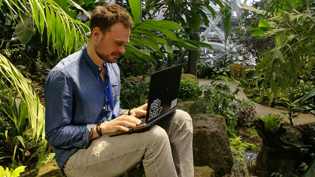 Axel Bopp sitzt in The Spheres und hat sein Laptop auf dem Schoß