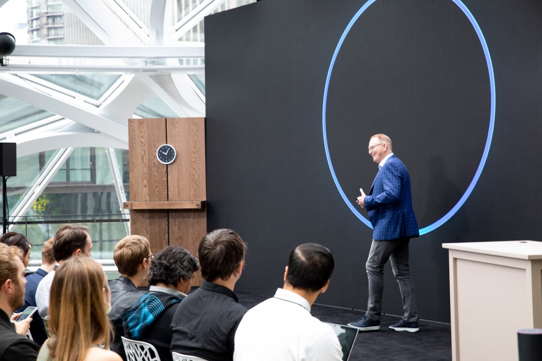 Amazon Devices VP David Limp on stage in front of a large image of the top of an Echo