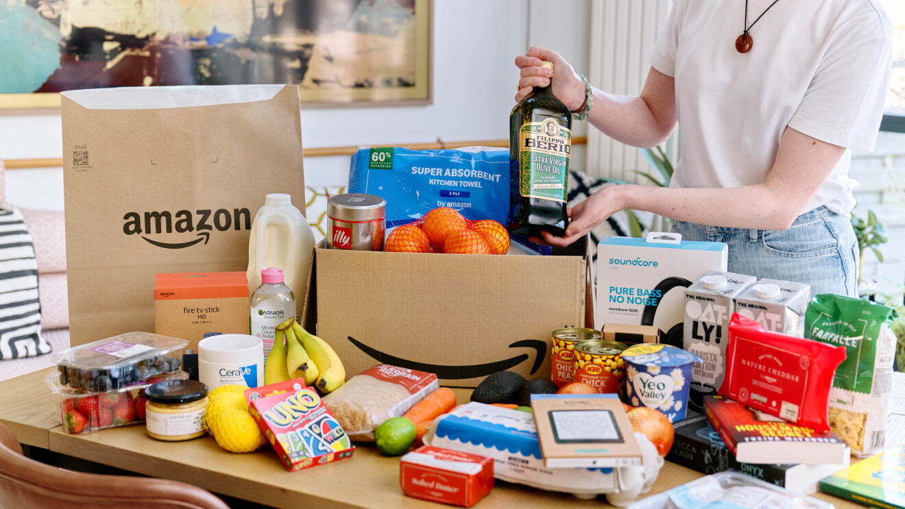 Woman standing by her Amazon grocery shop