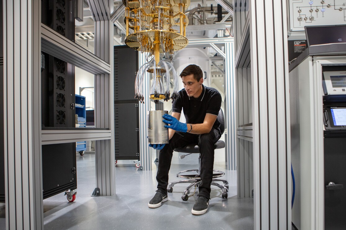 Photo of an AWS quantum hardware engineer working on a dilution refrigerator. 