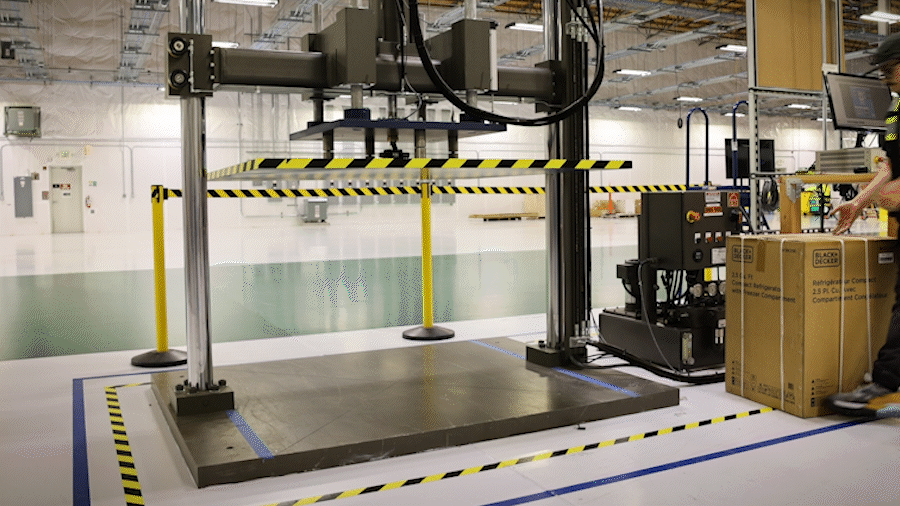An animated GIF of a box being pressed down on by a large metal plate above it.