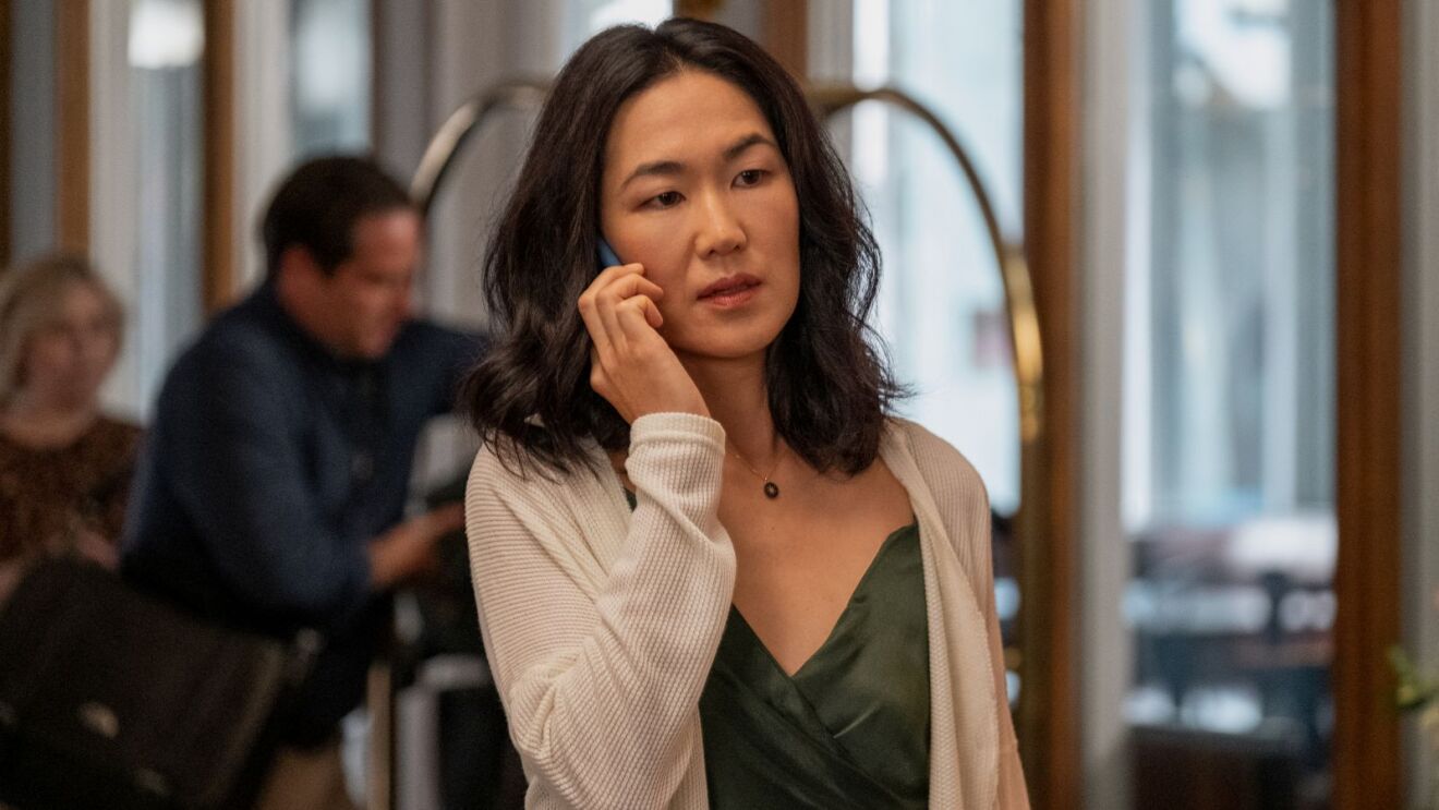 Laurel Park (Jackie Chung) with concerned expression holding phone to her face