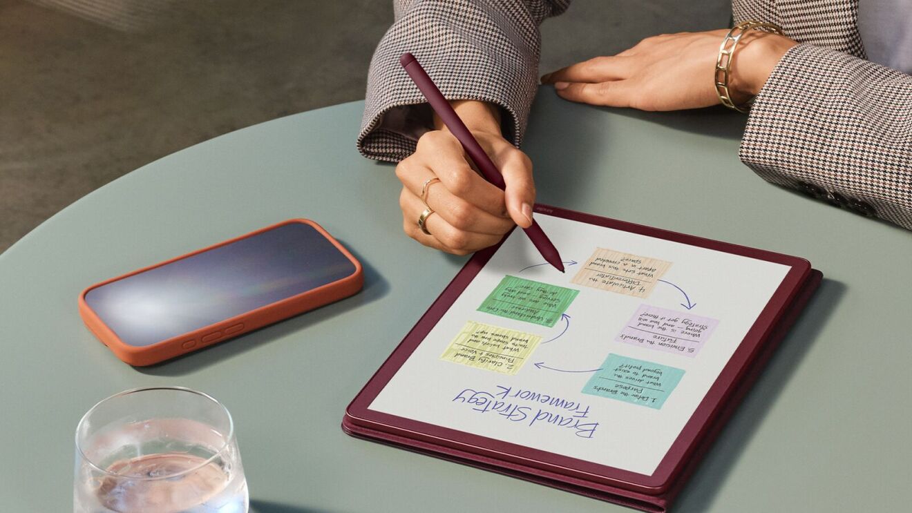 Person planning with colorful sticky notes on digital tablet