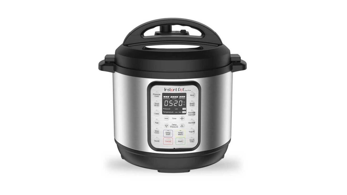The Instant Pot pressure cooker. It's a mid-size kitchen appliance with a silver base and a black lid. It also has a pad on the front with various buttons and a screen.