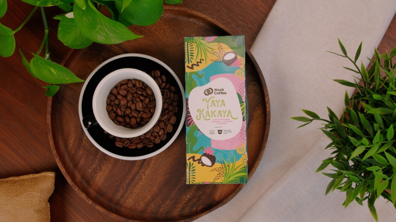 A box of coffee from Hook Coffee placed next to a cup