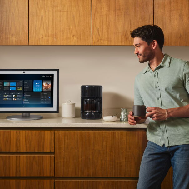 Man in kitchen drinking a coffee and talking to Alexa+