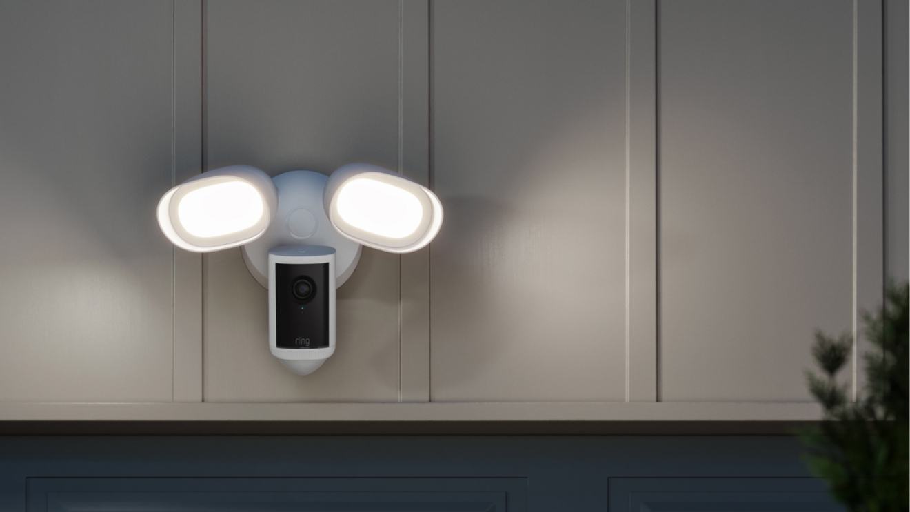 Smart floodlight camera mounted on exterior wall